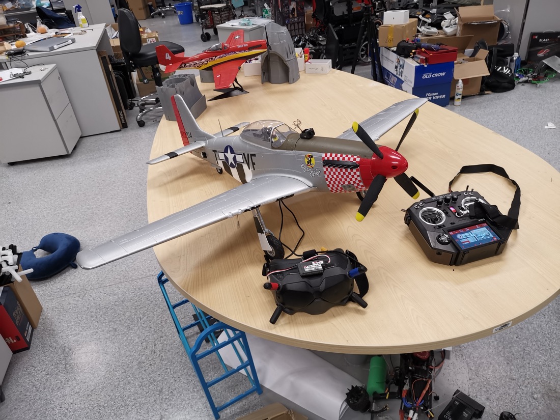 An RC P-51 Mustang with a radio transmitter